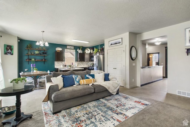 6961 W Goblin Valley Cv S, West Jordan, UT 84081 - living room with an inviting chandelier, a textured ceiling, and visible vents