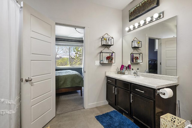 6961 W Goblin Valley Cv S, West Jordan, UT 84081 - ensuite bathroom featuring ensuite bath, vanity, tile patterned flooring, and baseboards