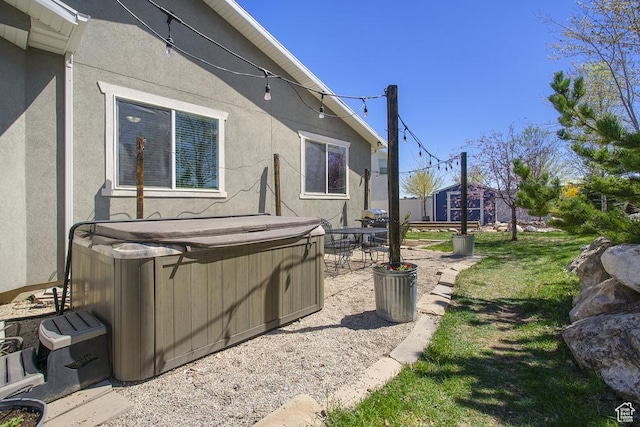 6961 W Goblin Valley Cv S, West Jordan, UT 84081 - exterior space with a patio area, a hot tub, and stucco siding