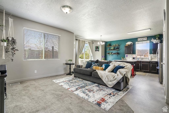 6961 W Goblin Valley Cv S, West Jordan, UT 84081 - living area featuring baseboards, a textured ceiling, and a chandelier