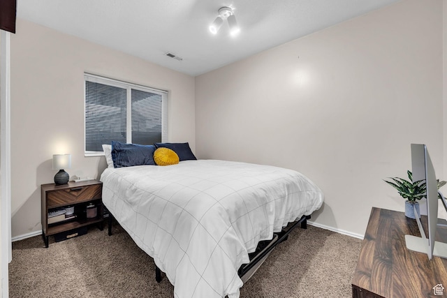 carpeted bedroom with baseboards and visible vents
