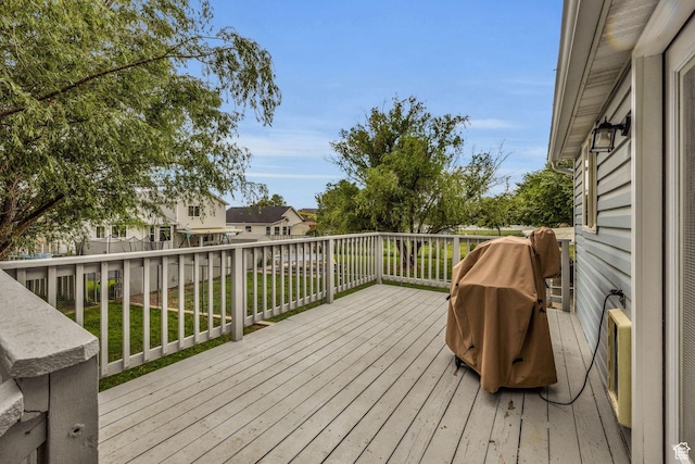 wooden deck featuring a lawn and fence