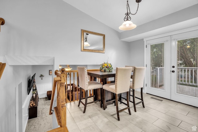dining room with vaulted ceiling, visible vents, and french doors