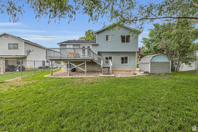 back of property with stairway, a storage shed, fence, a yard, and a wooden deck