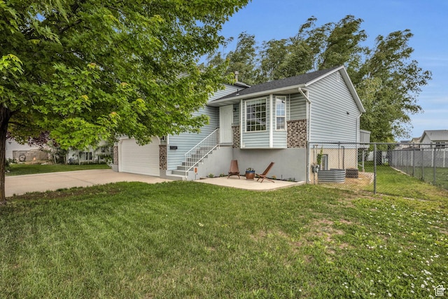 view of front of property with fence, driveway, a front yard, and a garage