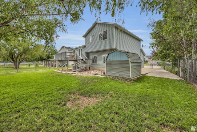 back of property featuring stairway, a lawn, fence private yard, and a deck
