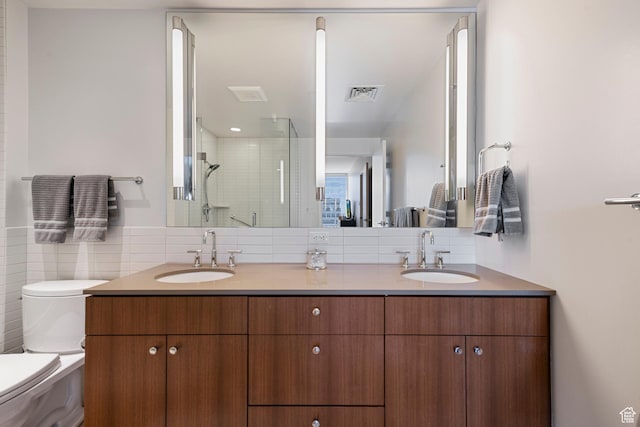 bathroom featuring visible vents, a sink, a shower stall, and double vanity
