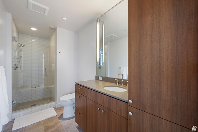 full bath featuring toilet, vanity, visible vents, and a stall shower