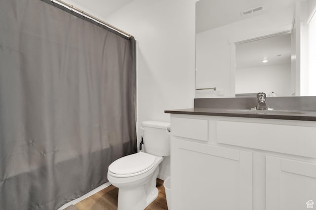 1751 E Wolverine Way, Eagle Mountain, UT 84005 - full bath with vanity, toilet, visible vents, wood finished floors, and shower / bath combination with curtain