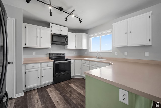kitchen with light countertops, a sink, electric range, and dark wood finished floors