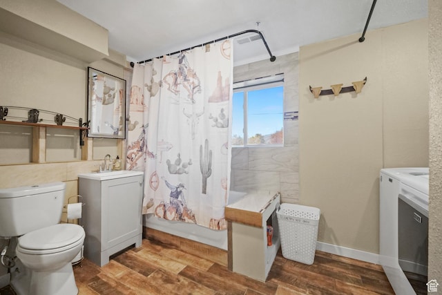 bathroom featuring toilet, vanity, shower / bath combination with curtain, and wood finished floors