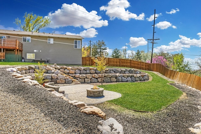 view of yard featuring a fire pit, a patio area, and a fenced backyard