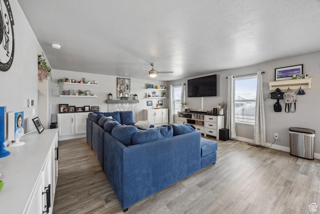 2448 W Anne Ave S, West Haven, UT 84401 - living room featuring light wood-style flooring, baseboards, a textured ceiling, and ceiling fan