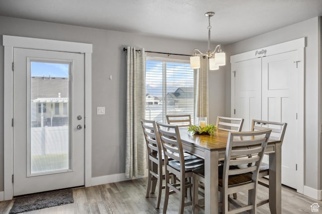 2448 W Anne Ave S, West Haven, UT 84401 - dining area with an inviting chandelier, light wood finished floors, and baseboards