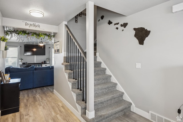 2448 W Anne Ave S, West Haven, UT 84401 - stairway featuring wood finished floors, visible vents, and baseboards
