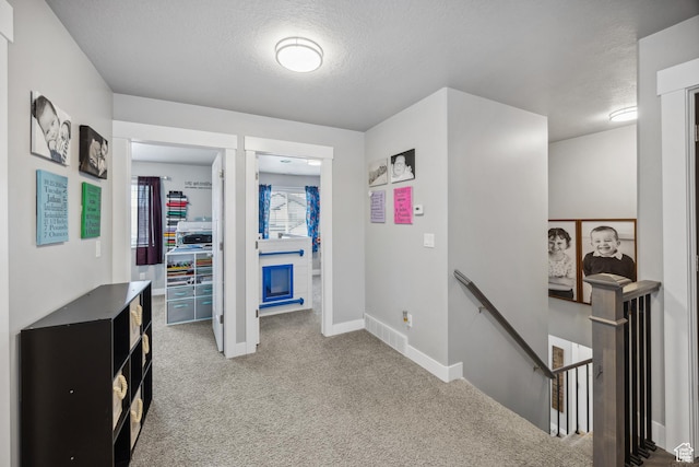 2448 W Anne Ave S, West Haven, UT 84401 - hallway featuring baseboards, carpet flooring, an upstairs landing, and a textured ceiling