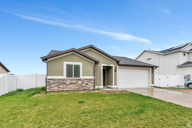 1784 S 360 W, Payson, UT 84651 - view of front of home with a garage, driveway, fence, a front yard, and stucco siding