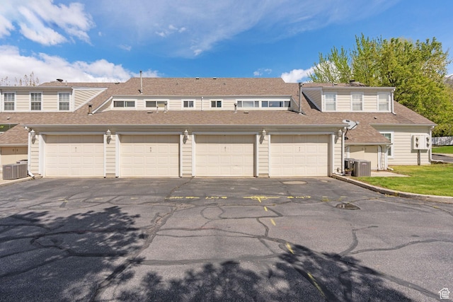 81 W Pheasantbrook Cir N, Centerville, UT 84014 - townhome / multi-family property featuring central air condition unit, a shingled roof, and community garages