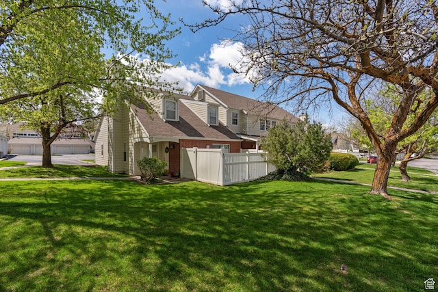 81 W Pheasantbrook Cir N, Centerville, UT 84014 - view of property exterior with brick siding, a lawn, a shingled roof, and fence
