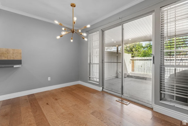 81 W Pheasantbrook Cir N, Centerville, UT 84014 - unfurnished dining area with wood finished floors, an inviting chandelier, baseboards, ornamental molding, and visible vents