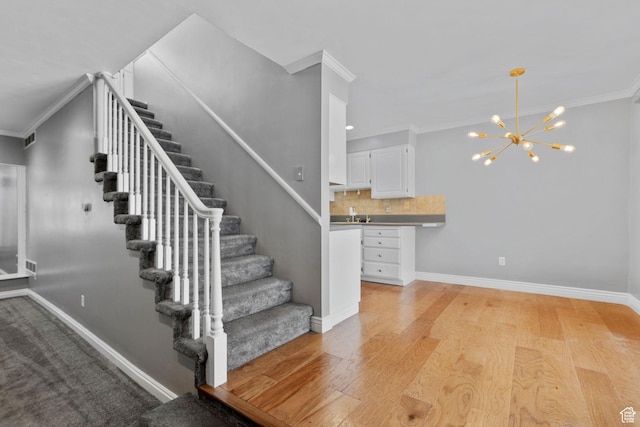 81 W Pheasantbrook Cir N, Centerville, UT 84014 - staircase featuring an inviting chandelier, wood finished floors, visible vents, crown molding, and baseboards