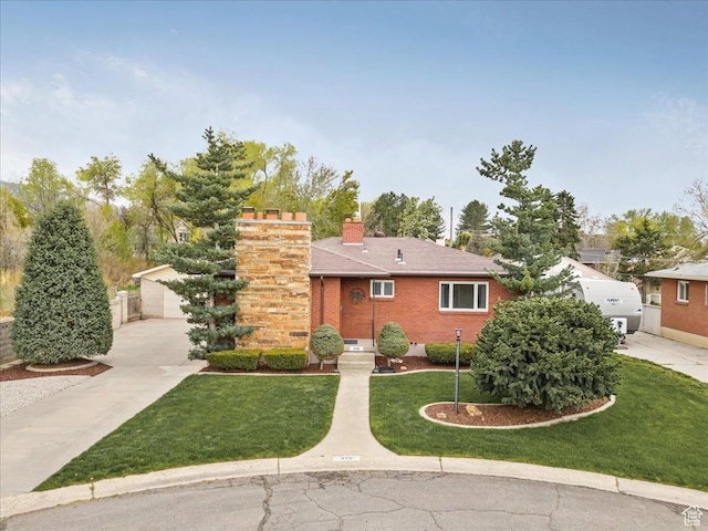 490 E 6990 S, Midvale, UT 84047 - view of front of home with a chimney, brick siding, and a front lawn