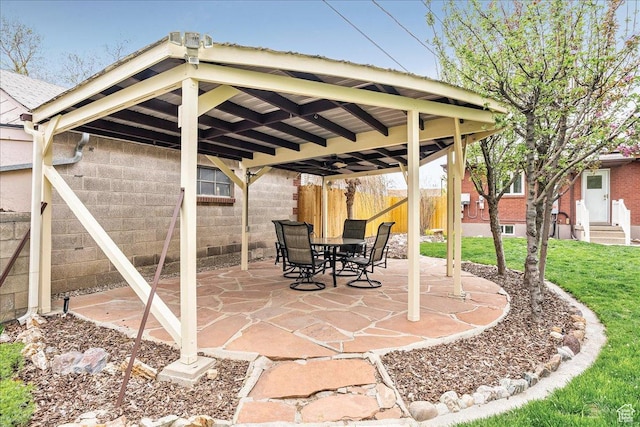 view of patio / terrace with fence, entry steps, and a gazebo