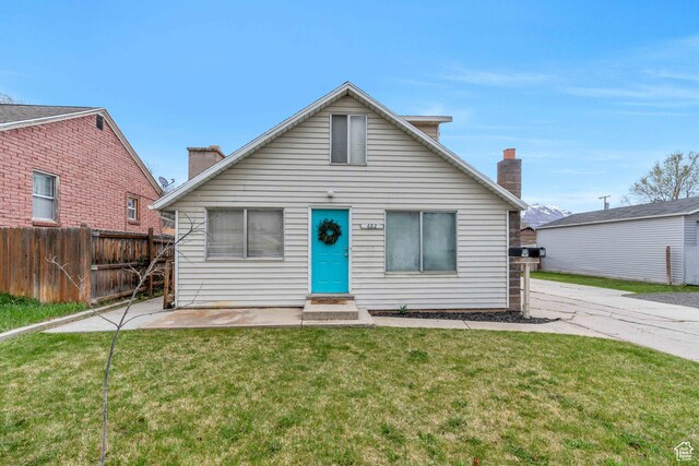 682 N 700 W, Provo, UT 84601 - bungalow featuring a front yard, entry steps, a chimney, and fence