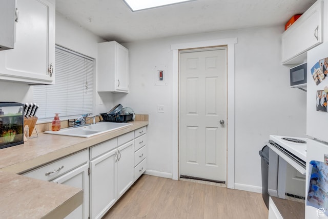 682 N 700 W, Provo, UT 84601 - kitchen featuring light wood finished floors, light countertops, white cabinets, and a sink