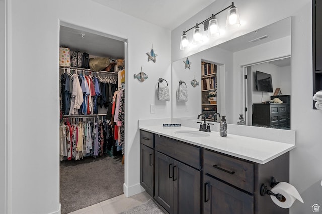 551 S 1020 W Unit 102, American Fork, UT 84003 - bathroom featuring baseboards, visible vents, a spacious closet, tile patterned flooring, and vanity