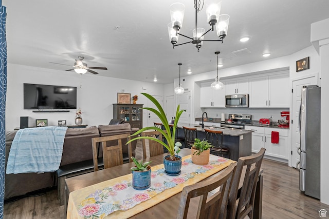 551 S 1020 W Unit 102, American Fork, UT 84003 - dining space featuring dark wood finished floors, recessed lighting, and ceiling fan with notable chandelier