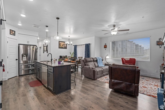 551 S 1020 W Unit 102, American Fork, UT 84003 - kitchen featuring a sink, ceiling fan with notable chandelier, open floor plan, a breakfast bar area, and appliances with stainless steel finishes
