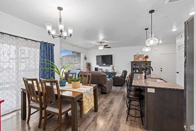 551 S 1020 W Unit 102, American Fork, UT 84003 - dining room featuring ceiling fan with notable chandelier, wood finished floors, and visible vents
