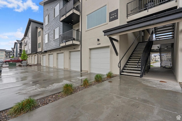 551 S 1020 W Unit 102, American Fork, UT 84003 - view of building exterior with an attached garage, stairway, and driveway
