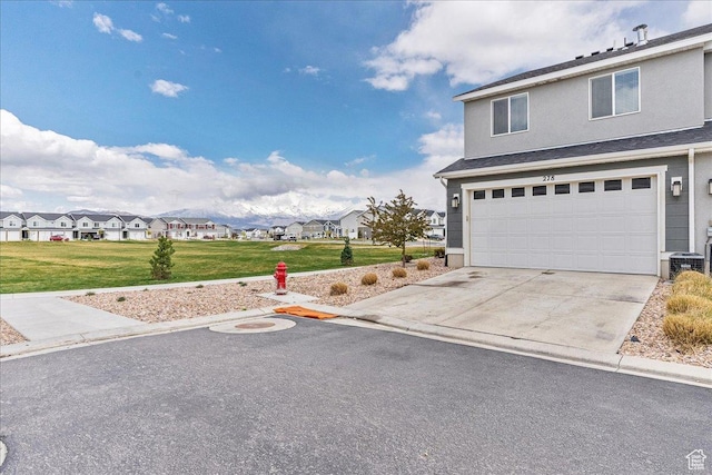 278 N Portside Ln, Saratoga Springs, UT 84045 - traditional home with a residential view, a front lawn, driveway, an attached garage, and stucco siding