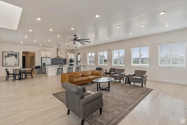 278 N Portside Ln, Saratoga Springs, UT 84045 - living room with light wood-style flooring, baseboards, and recessed lighting