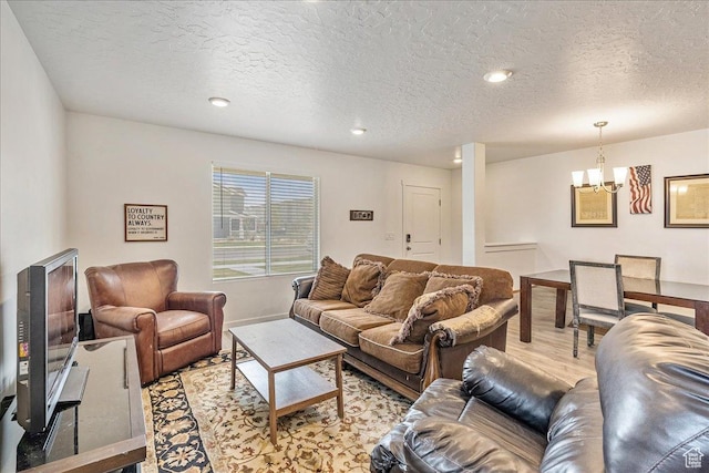 278 N Portside Ln, Saratoga Springs, UT 84045 - living room with baseboards, a chandelier, light wood-style floors, and a textured ceiling