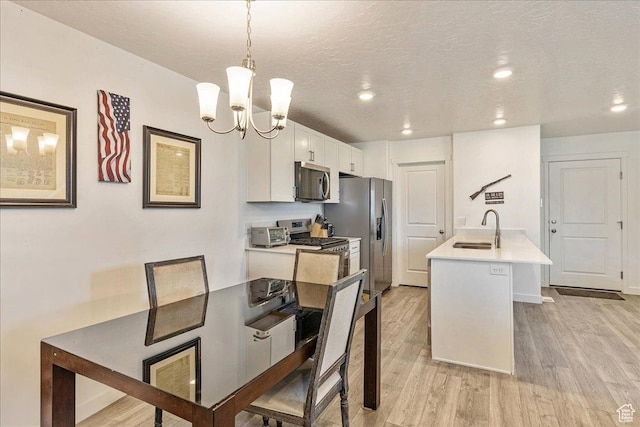278 N Portside Ln, Saratoga Springs, UT 84045 - dining area with a textured ceiling, a chandelier, light wood-style floors, baseboards, and recessed lighting