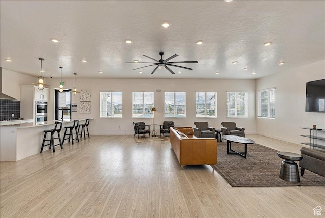 278 N Portside Ln, Saratoga Springs, UT 84045 - living area with a ceiling fan, light wood-style floors, and a healthy amount of sunlight
