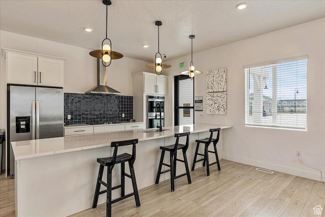 278 N Portside Ln, Saratoga Springs, UT 84045 - kitchen featuring tasteful backsplash, light wood-style flooring, appliances with stainless steel finishes, and a sink
