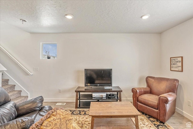278 N Portside Ln, Saratoga Springs, UT 84045 - living room with a textured ceiling, stairs, light wood finished floors, and baseboards