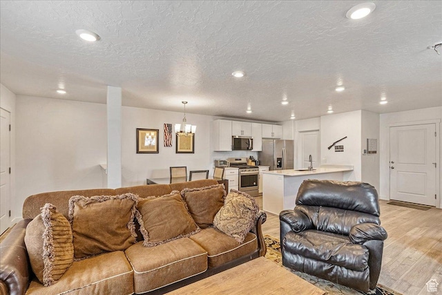 278 N Portside Ln, Saratoga Springs, UT 84045 - living area with recessed lighting, light wood-style flooring, a textured ceiling, and a notable chandelier