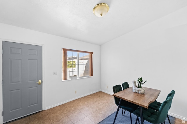 dining area featuring tile patterned floors and baseboards