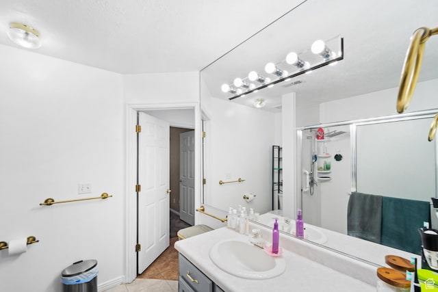 bathroom featuring a stall shower, vanity, and tile patterned floors