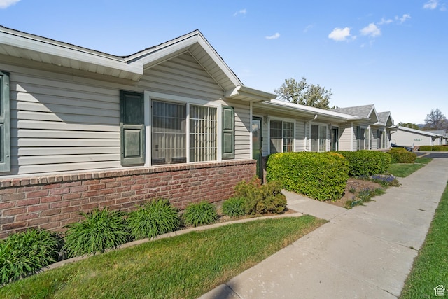 view of side of home with brick siding