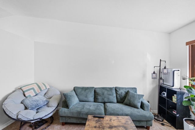 living room featuring carpet and baseboards