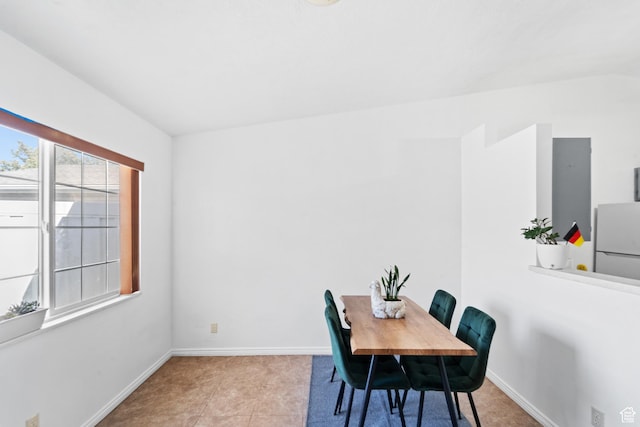 dining area with baseboards and tile patterned flooring