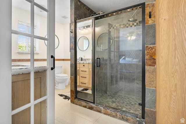 full bathroom featuring vanity, a shower stall, and toilet