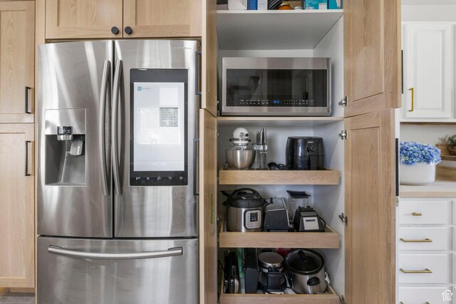 kitchen with light countertops, white cabinetry, and appliances with stainless steel finishes