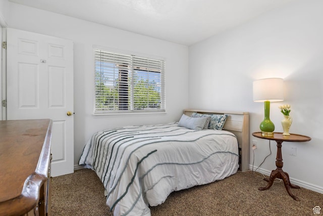 carpeted bedroom featuring baseboards